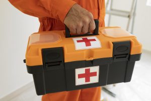 portrait-man-with-safety-protection-equipment-and-first-aid-kit